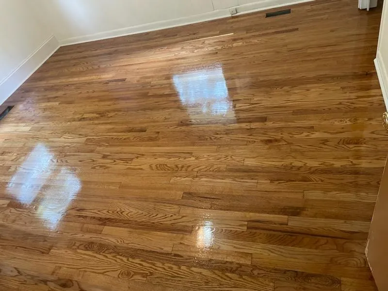 Golden oak hardwood floor with a fresh finish reflecting window light